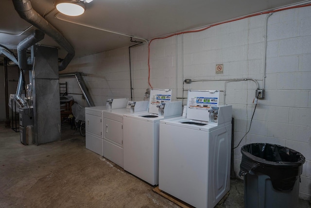 433 E 13th Ave, Columbus, OH 43201 - laundry room featuring washer and clothes dryer, concrete block wall, and heating unit