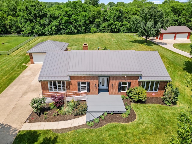 1550 Hiner Rd, Orient, OH 43146 - view of front facade featuring brick siding, a standing seam roof, a chimney, a metal roof, and a front lawn