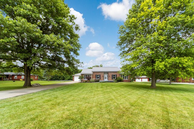 1550 Hiner Rd, Orient, OH 43146 - ranch-style house with driveway, a front lawn, a garage, a metal roof, and a standing seam roof