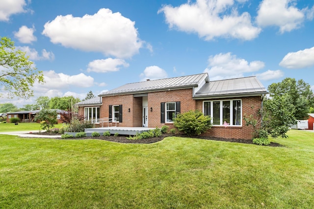 1550 Hiner Rd, Orient, OH 43146 - view of front of home featuring brick siding, a standing seam roof, a front lawn, and a metal roof
