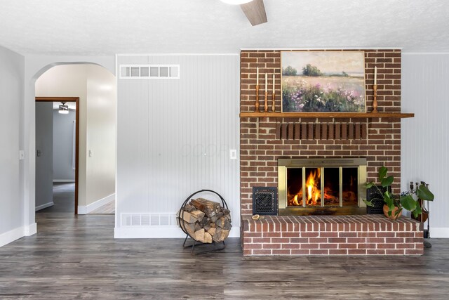 1550 Hiner Rd, Orient, OH 43146 - unfurnished living room featuring wood finished floors, arched walkways, and a brick fireplace