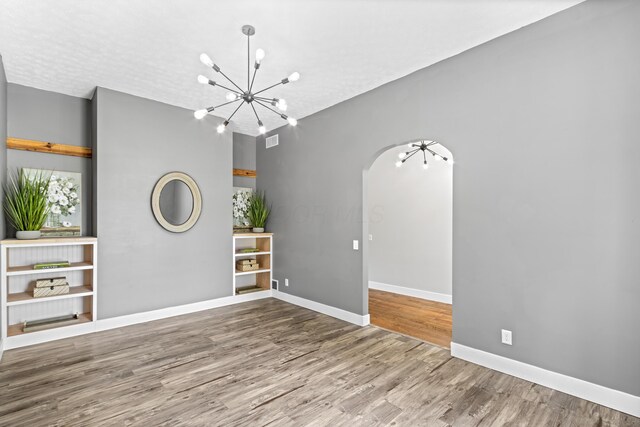 1550 Hiner Rd, Orient, OH 43146 - spare room featuring a chandelier, wood finished floors, and arched walkways