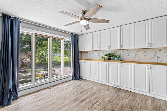 1550 Hiner Rd, Orient, OH 43146 - kitchen with light wood finished floors, white cabinetry, a textured ceiling, ceiling fan, and butcher block countertops