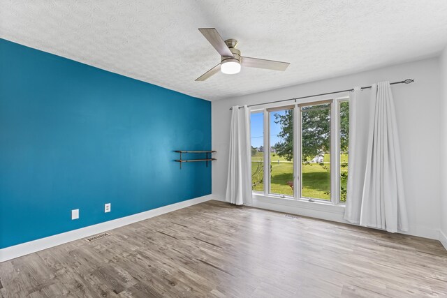 1550 Hiner Rd, Orient, OH 43146 - spare room with a textured ceiling, wood finished floors, and a ceiling fan