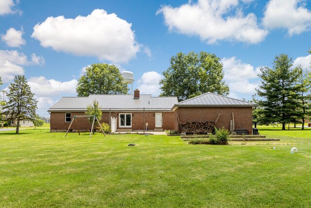 1550 Hiner Rd, Orient, OH 43146 - back of house with a lawn, a metal roof, brick siding, and a chimney