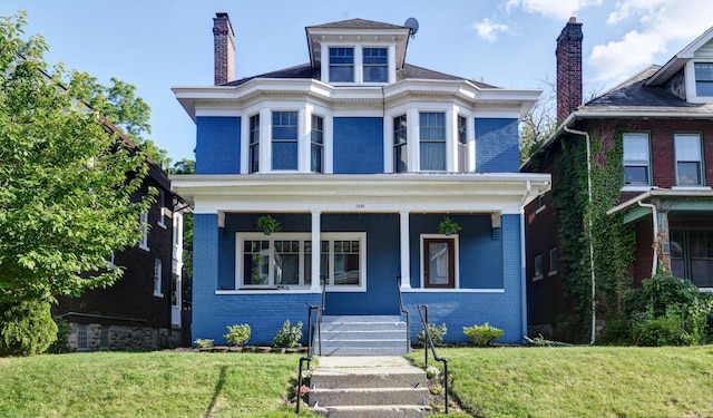 1433 Madison Ave, Columbus, OH 43205 - traditional style home featuring brick siding, covered porch, a front yard, and a chimney