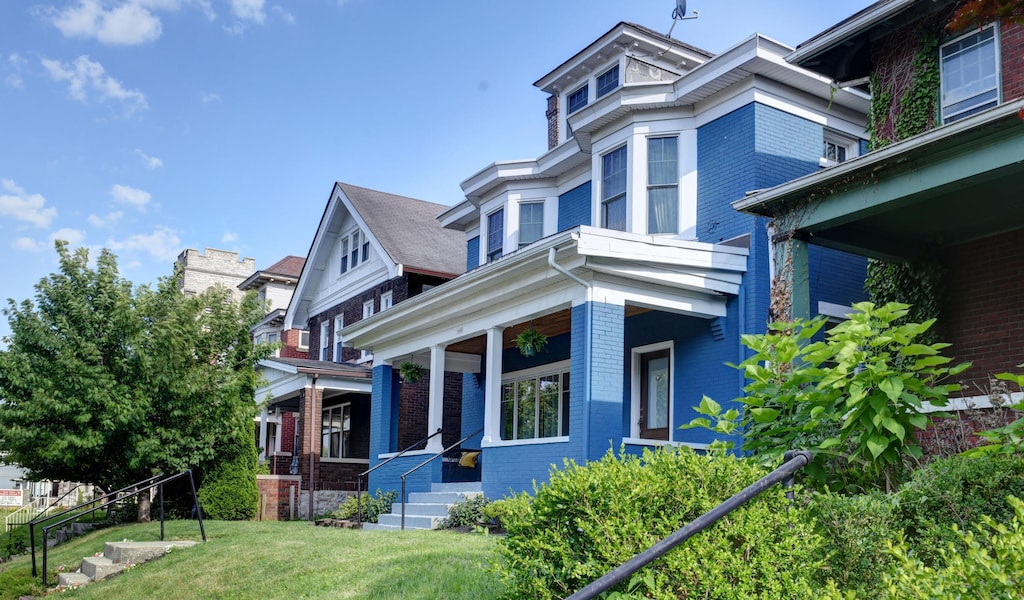 1433 Madison Ave, Columbus, OH 43205 - view of front of house featuring brick siding, covered porch, and a front lawn
