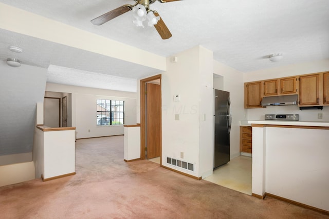 1176 Cambridge Way, Pickerington, OH 43147 - kitchen with freestanding refrigerator, under cabinet range hood, light colored carpet, range, and light countertops