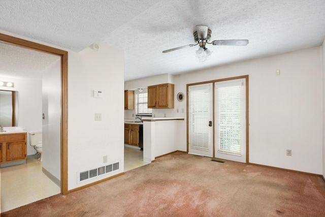 1176 Cambridge Way, Pickerington, OH 43147 - unfurnished living room featuring ceiling fan, a textured ceiling, and light carpet