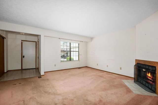 1176 Cambridge Way, Pickerington, OH 43147 - unfurnished living room with carpet floors, a tiled fireplace, and a textured ceiling