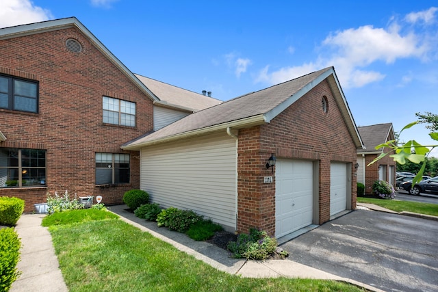 1176 Cambridge Way, Pickerington, OH 43147 - view of side of home with brick siding, driveway, roof with shingles, and a garage