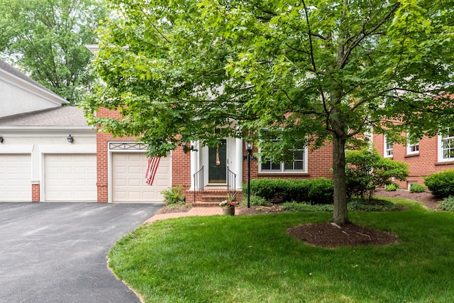 1359 White Oak Ln, New Albany, OH 43054 - view of property hidden behind natural elements with brick siding, driveway, a garage, and a front lawn