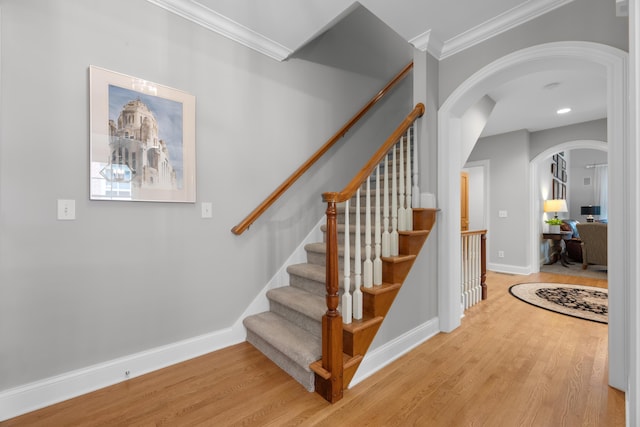 1359 White Oak Ln, New Albany, OH 43054 - staircase with wood finished floors, arched walkways, and ornamental molding