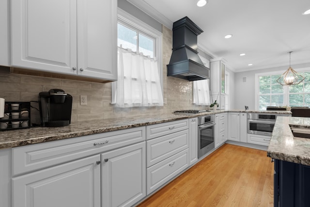 1359 White Oak Ln, New Albany, OH 43054 - kitchen featuring appliances with stainless steel finishes, premium range hood, crown molding, recessed lighting, and white cabinetry