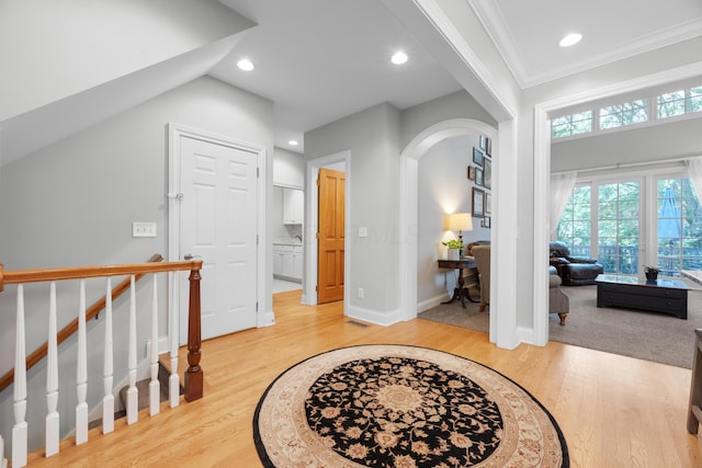 1359 White Oak Ln, New Albany, OH 43054 - entrance foyer featuring light wood-style floors, arched walkways, ornamental molding, and recessed lighting