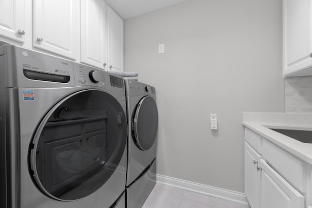 1359 White Oak Ln, New Albany, OH 43054 - washroom with cabinet space, washing machine and dryer, and light tile patterned floors