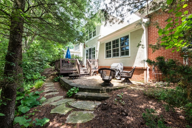 1359 White Oak Ln, New Albany, OH 43054 - rear view of property featuring stucco siding, a wooden deck, a patio area, and brick siding