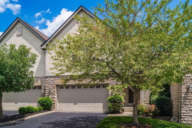 993 Starlight Ln, Westerville, OH 43082 - view of front facade with stucco siding, asphalt driveway, and stone siding