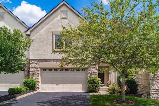 993 Starlight Ln, Westerville, OH 43082 - view of front of home with stucco siding, stone siding, and driveway