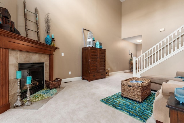 993 Starlight Ln, Westerville, OH 43082 - living room with carpet floors, stairway, a high ceiling, and a tile fireplace