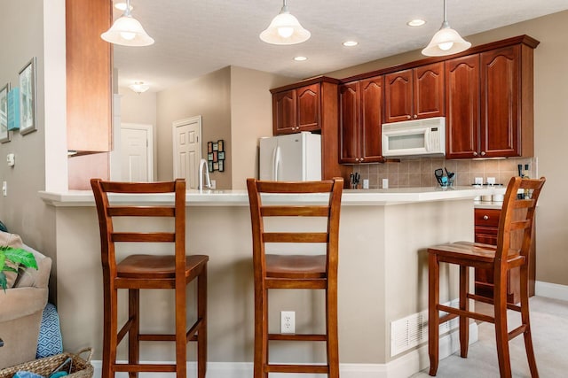 993 Starlight Ln, Westerville, OH 43082 - kitchen featuring white appliances, a peninsula, pendant lighting, and recessed lighting