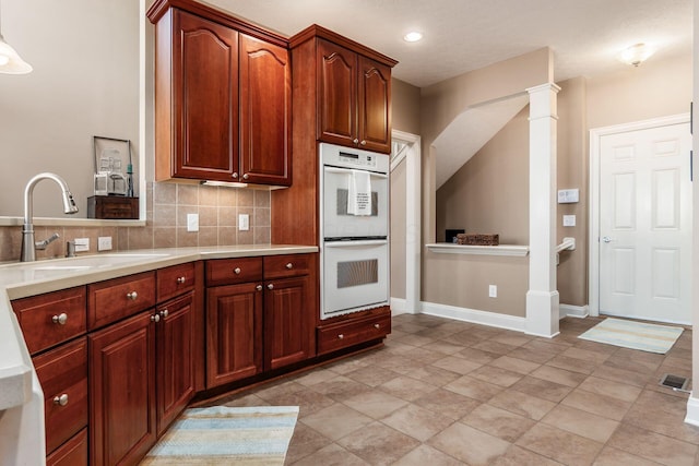993 Starlight Ln, Westerville, OH 43082 - kitchen with white double oven, light countertops, decorative backsplash, and recessed lighting