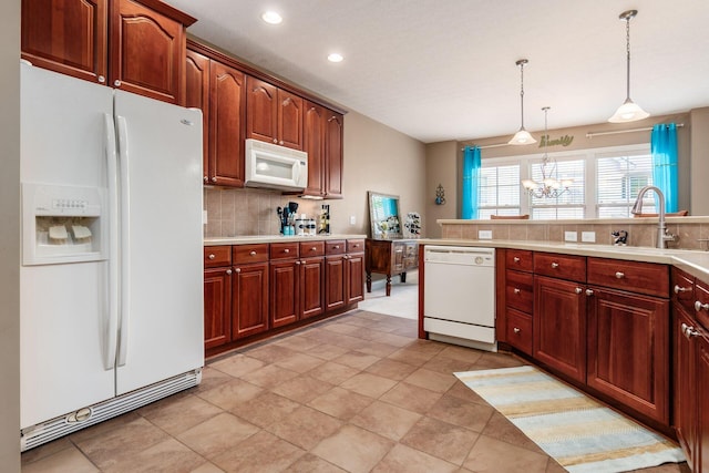 993 Starlight Ln, Westerville, OH 43082 - kitchen with white appliances, backsplash, a chandelier, light countertops, and recessed lighting
