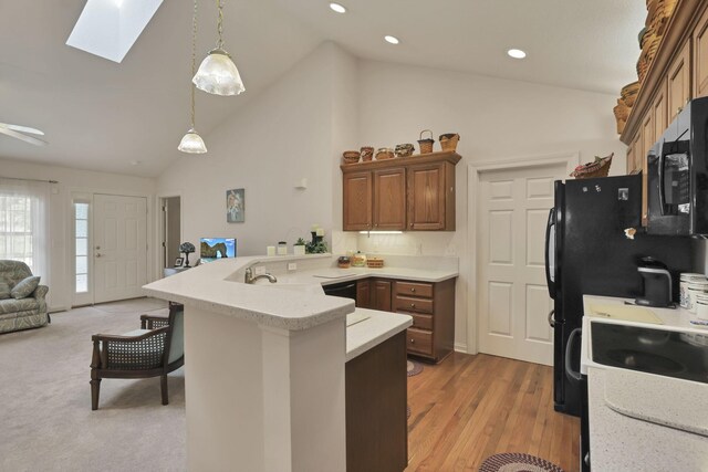 786 Stone Ridge Way, Newark, OH 43055 - kitchen featuring a peninsula, a skylight, open floor plan, light countertops, and high vaulted ceiling