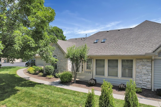 786 Stone Ridge Way, Newark, OH 43055 - view of front of house featuring stone siding, roof with shingles, and a front lawn