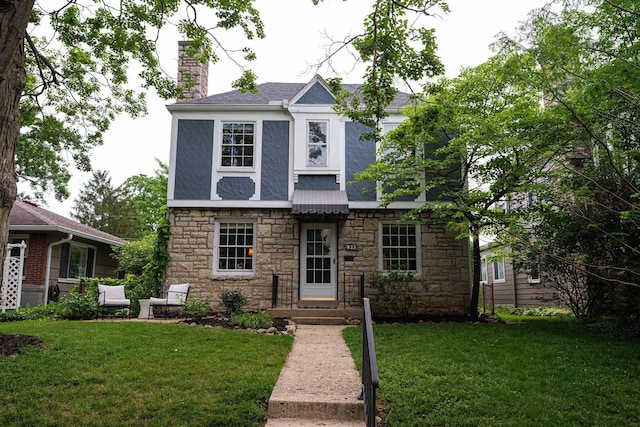 922 S Remington Rd, Columbus, OH 43209 - view of front of house with stone siding, a chimney, and a front lawn