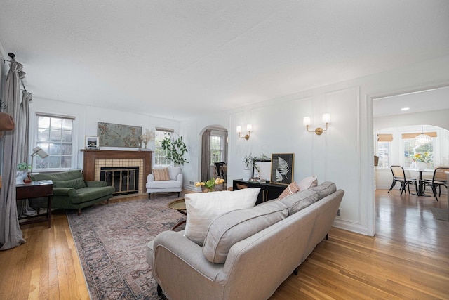 922 S Remington Rd, Columbus, OH 43209 - living room with arched walkways, light wood-style flooring, and healthy amount of natural light