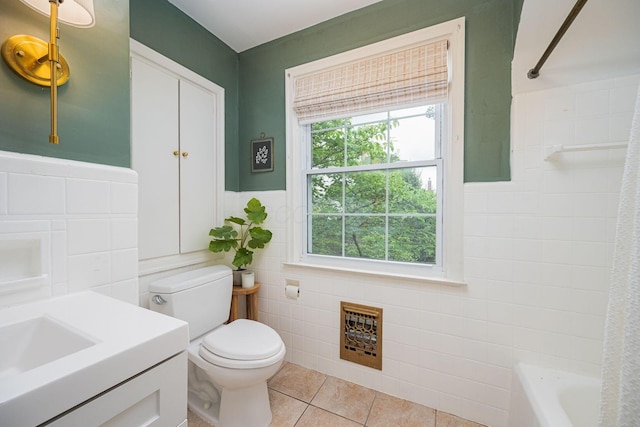922 S Remington Rd, Columbus, OH 43209 - full bath with tile walls, tile patterned flooring, vanity, wainscoting, and shower / bathtub combination with curtain