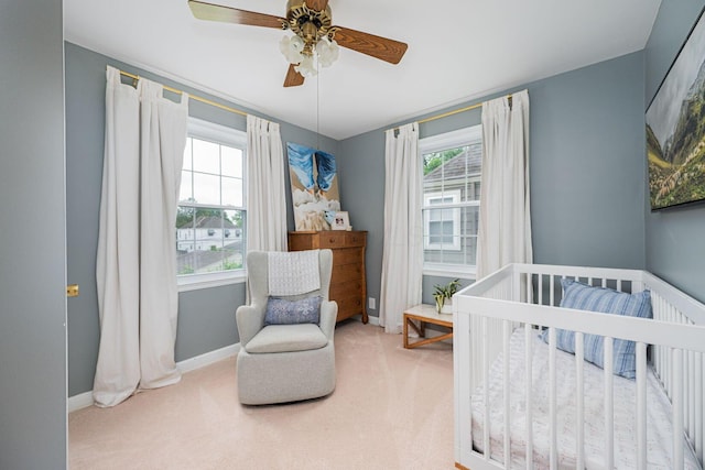 922 S Remington Rd, Columbus, OH 43209 - carpeted bedroom with multiple windows, a nursery area, and a ceiling fan