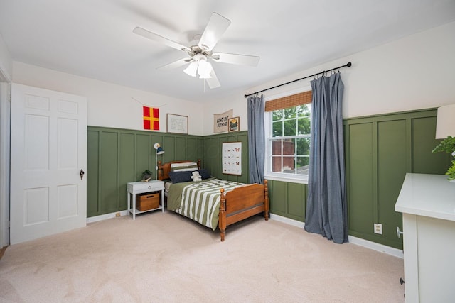 922 S Remington Rd, Columbus, OH 43209 - bedroom with a decorative wall, light colored carpet, wainscoting, and a ceiling fan