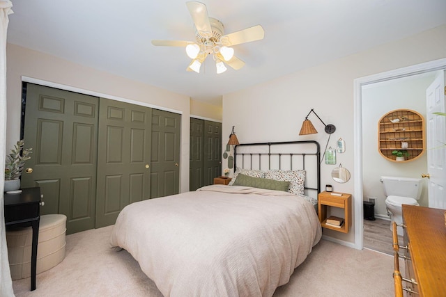 922 S Remington Rd, Columbus, OH 43209 - bedroom with multiple closets, light carpet, a ceiling fan, and ensuite bath
