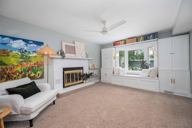 922 S Remington Rd, Columbus, OH 43209 - living area featuring a ceiling fan, a brick fireplace, carpet floors, and a textured ceiling