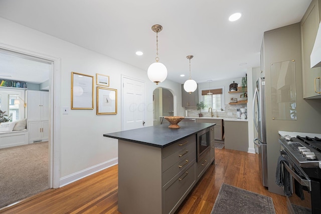 922 S Remington Rd, Columbus, OH 43209 - kitchen with gray cabinetry, appliances with stainless steel finishes, arched walkways, a kitchen island, and recessed lighting