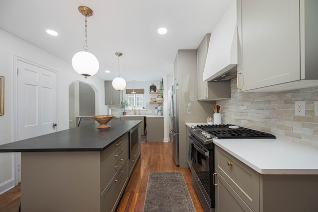 922 S Remington Rd, Columbus, OH 43209 - kitchen with range with gas stovetop, gray cabinetry, custom exhaust hood, arched walkways, and a kitchen island