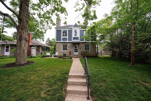 922 S Remington Rd, Columbus, OH 43209 - tudor house featuring stone siding, a chimney, and a front lawn