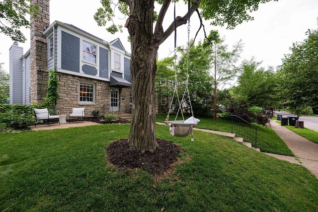 922 S Remington Rd, Columbus, OH 43209 - view of front of property with stone siding, a chimney, and a front yard