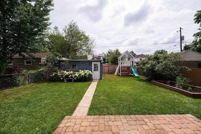 922 S Remington Rd, Columbus, OH 43209 - fenced backyard featuring a vegetable garden, an outdoor structure, and a playground