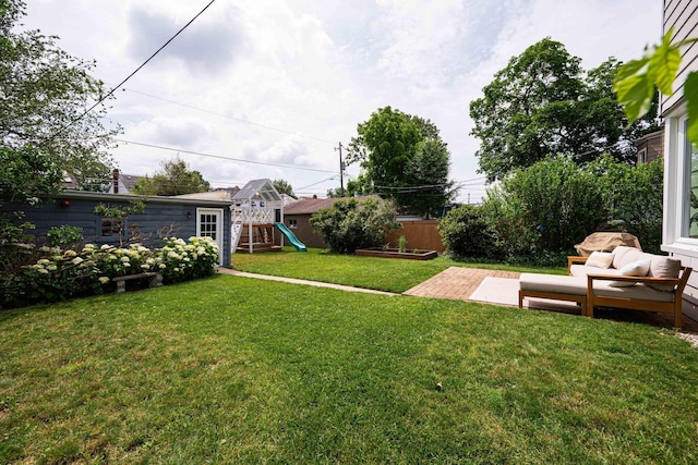 922 S Remington Rd, Columbus, OH 43209 - fenced backyard with a playground, a patio area, an outdoor living space, and an outbuilding