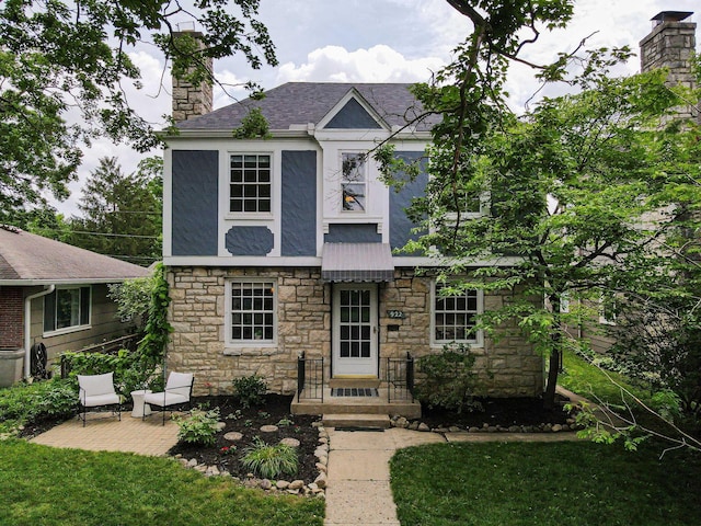922 S Remington Rd, Columbus, OH 43209 - view of front of home featuring stone siding, a chimney, stucco siding, a patio area, and a front yard