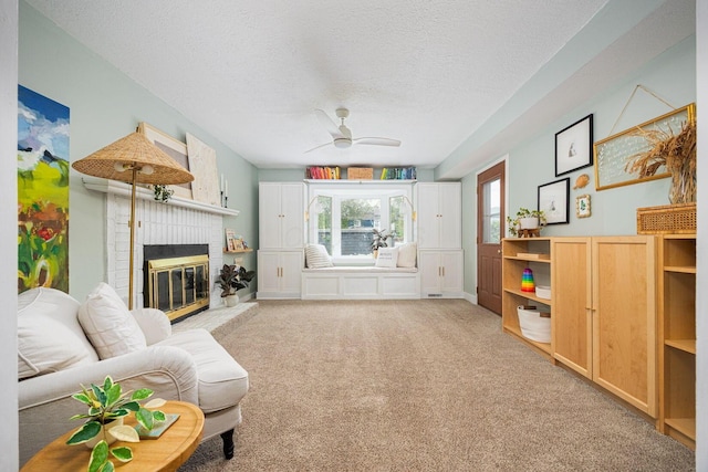 922 S Remington Rd, Columbus, OH 43209 - carpeted living room with ceiling fan, a textured ceiling, and a fireplace