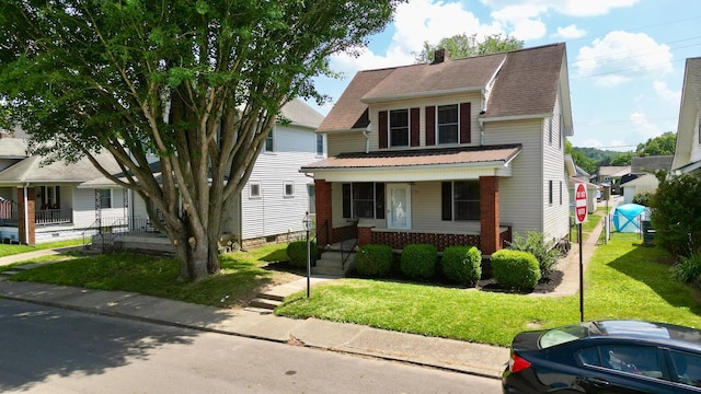 554 Laurel St, Chillicothe, OH 45601 - view of front of home with covered porch, a front lawn, brick siding, and a chimney