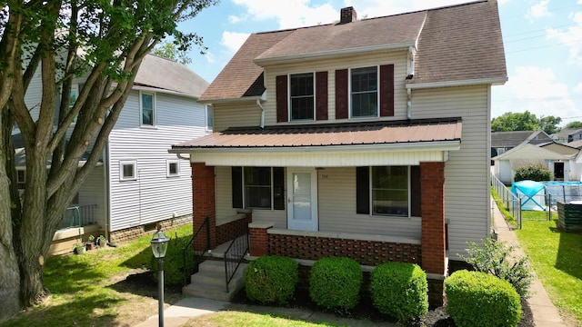 554 Laurel St, Chillicothe, OH 45601 - view of front of property with a porch, a chimney, and brick siding