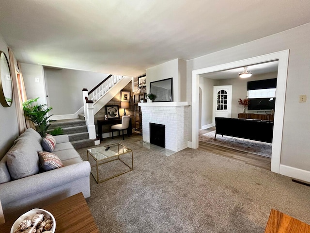 554 Laurel St, Chillicothe, OH 45601 - carpeted living room featuring a fireplace and stairway