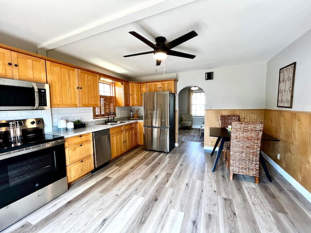 554 Laurel St, Chillicothe, OH 45601 - kitchen featuring appliances with stainless steel finishes, arched walkways, plenty of natural light, light countertops, and wainscoting