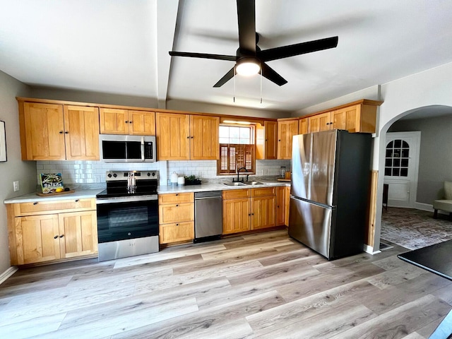 554 Laurel St, Chillicothe, OH 45601 - kitchen featuring appliances with stainless steel finishes, arched walkways, a ceiling fan, and decorative backsplash
