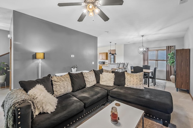 861 Summerville Dr, Delaware, OH 43015 - living area featuring ceiling fan, light carpet, and a chandelier